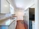 Bright kitchen features white cabinets, stainless steel appliances, and wood flooring at 910 Lakeside Dr, Largo, FL 33778