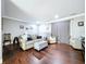 Open-concept living room with hardwood floors, neutral tones, and comfortable seating arrangements at 910 Lakeside Dr, Largo, FL 33778