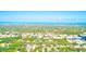 Distant aerial view of Tampa Bay showing mature trees and a neighborhood at 921 Woodland Dr, Palm Harbor, FL 34683