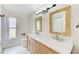 Beautiful bathroom featuring double sinks, framed mirrors and modern lighting at 921 Woodland Dr, Palm Harbor, FL 34683