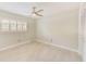 Bright bedroom with modern ceiling fan, neutral paint, plantation shutters and tile floors at 921 Woodland Dr, Palm Harbor, FL 34683