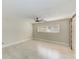 Bright bedroom with fan, window, and a sliding barn door closet at 921 Woodland Dr, Palm Harbor, FL 34683