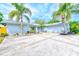 Inviting single Gathering home featuring mature palm trees, large driveway and two car garage at 921 Woodland Dr, Palm Harbor, FL 34683