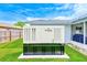 This is a close up of the Generac generator with a screened patio and lawn in the background at 921 Woodland Dr, Palm Harbor, FL 34683