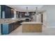 Modern kitchen features custom cabinets, stainless steel appliances, and a large island with stone countertop at 921 Woodland Dr, Palm Harbor, FL 34683