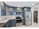 Kitchen boasts stainless steel appliances, stylish cabinetry and marble countertops at 921 Woodland Dr, Palm Harbor, FL 34683