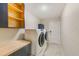 Laundry room features modern washer and dryer, with stylish cabinetry and a butcher block counter at 921 Woodland Dr, Palm Harbor, FL 34683