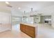 Spacious living room with stylish island, stone fireplace and an abundance of natural light at 921 Woodland Dr, Palm Harbor, FL 34683