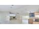 Spacious living room boasting a fireplace, tile floors, and an open layout into the modern kitchen at 921 Woodland Dr, Palm Harbor, FL 34683