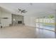 Spacious living room featuring fireplace, ceiling fan, tile floors and sliding glass doors to patio at 921 Woodland Dr, Palm Harbor, FL 34683