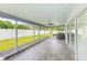 Relax on this expansive screened lanai, complete with ceiling fan and tile flooring at 921 Woodland Dr, Palm Harbor, FL 34683