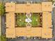 Aerial view of a condo building with a central courtyard featuring a pool, palm trees, and manicured lawn at 12760 Indian Rocks Rd # 571, Largo, FL 33774