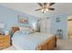 Spacious blue bedroom featuring a ceiling fan, light-colored walls, and closet at 12760 Indian Rocks Rd # 571, Largo, FL 33774