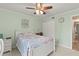 Cozy bedroom with light-green walls, queen bed, ceiling fan, and closet at 12760 Indian Rocks Rd # 571, Largo, FL 33774