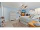 Bright blue bedroom with a ceiling fan, large windows, and comfortable furnishings at 12760 Indian Rocks Rd # 571, Largo, FL 33774