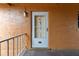 Exterior front door to unit 571 featuring glass panes, security features and textured stucco siding at 12760 Indian Rocks Rd # 571, Largo, FL 33774