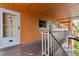 Exterior hallway leading to unit, featuring stucco walls and a metal railing at 12760 Indian Rocks Rd # 571, Largo, FL 33774