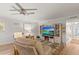 Living room with a large TV, decorative shelving, and comfortable seating at 12760 Indian Rocks Rd # 571, Largo, FL 33774