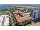 Aerial view highlights the condominium complex with pool, landscaping, and nearby airport at 100 4Th S Ave # 207, St Petersburg, FL 33701