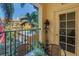 Cozy balcony with seating offers views of the community pool and lush tropical landscaping at 100 4Th S Ave # 207, St Petersburg, FL 33701
