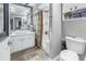 Modern bathroom featuring a vessel sink, walk-in shower, and decorative pebble tile flooring and shelving at 100 4Th S Ave # 207, St Petersburg, FL 33701
