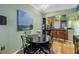 Cozy dining area with modern lighting fixtures, and a nearby breakfast bar extending from a stainless steel kitchen at 100 4Th S Ave # 207, St Petersburg, FL 33701