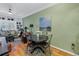 Cozy dining area with hardwood floors and a round table, adjacent to the inviting living room at 100 4Th S Ave # 207, St Petersburg, FL 33701