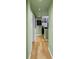 Hallway with green walls and hard wood floors at 100 4Th S Ave # 207, St Petersburg, FL 33701