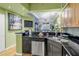 Bright kitchen with black granite counters, stainless steel appliances, and a convenient breakfast bar at 100 4Th S Ave # 207, St Petersburg, FL 33701