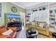 Inviting living room with a sofa, wooden floors, custom shelving, and a television with a view to a balcony at 100 4Th S Ave # 207, St Petersburg, FL 33701