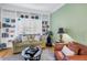 Relaxing living area featuring comfortable seating, wooden floors, and custom built-in shelving and shuttered windows at 100 4Th S Ave # 207, St Petersburg, FL 33701