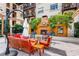 Outdoor living space with cozy fireplace, comfortable seating and mature trees in an outdoor area at 100 4Th S Ave # 207, St Petersburg, FL 33701