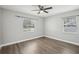Bedroom with hardwood flooring, ceiling fan, and natural light from two windows at 1000 8Th Sw Ave, Largo, FL 33770