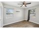 This bedroom features a ceiling fan, wood floors, and ample natural light at 1000 8Th Sw Ave, Largo, FL 33770