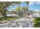 Charming home showcasing a brick driveway, well-kept landscaping, and classic curb appeal at 1000 8Th Sw Ave, Largo, FL 33770