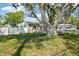 Charming home showcasing a large tree in front yard, well-kept landscaping, and curb appeal at 1000 8Th Sw Ave, Largo, FL 33770