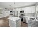 Open kitchen featuring stainless appliances, an island, and seamless flow to the living area at 1000 8Th Sw Ave, Largo, FL 33770