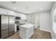 Modern kitchen featuring stainless appliances, grey backsplash, and a center island with quartz countertops at 1000 8Th Sw Ave, Largo, FL 33770