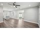 Open living room featuring wood-look floors, a ceiling fan, and sliding glass doors to the backyard at 1000 8Th Sw Ave, Largo, FL 33770