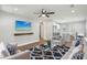 Cozy living room featuring a ceiling fan, stylish decor, and an open layout to the kitchen at 1000 8Th Sw Ave, Largo, FL 33770
