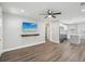Bright living room with wood floors and an open layout leading to a modern kitchen at 1000 8Th Sw Ave, Largo, FL 33770