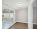 Bright sun room featuring modern wood flooring and sliding glass doors to fenced backyard at 1000 8Th Sw Ave, Largo, FL 33770