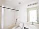 Bright bathroom features a tub-shower combo, white vanity, and neutral walls, creating a clean, functional space at 1001 Culbreath Green Ct, Ruskin, FL 33570