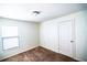 Cozy bedroom with neutral walls, carpet flooring, and a window offering natural light at 1001 Culbreath Green Ct, Ruskin, FL 33570