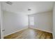 Bright bedroom features wood-look flooring, white walls, and a window at 1001 Culbreath Green Ct, Ruskin, FL 33570