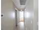 Bright hallway features neutral paint and tile flooring, connecting various rooms in the home at 1001 Culbreath Green Ct, Ruskin, FL 33570