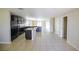 Spacious open-concept kitchen with dark cabinets, granite countertops, and tile flooring, perfect for entertaining at 1001 Culbreath Green Ct, Ruskin, FL 33570