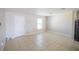 Neutral living room with white door and window, and tile flooring offering a blank canvas for personalized decor at 1001 Culbreath Green Ct, Ruskin, FL 33570