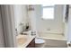 Cozy bathroom featuring a shower-tub combo, and updated fixtures at 10048 Cleghorn Dr, San Antonio, FL 33576