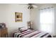 Simple bedroom with ceiling fan, window, and quaint decor at 10048 Cleghorn Dr, San Antonio, FL 33576